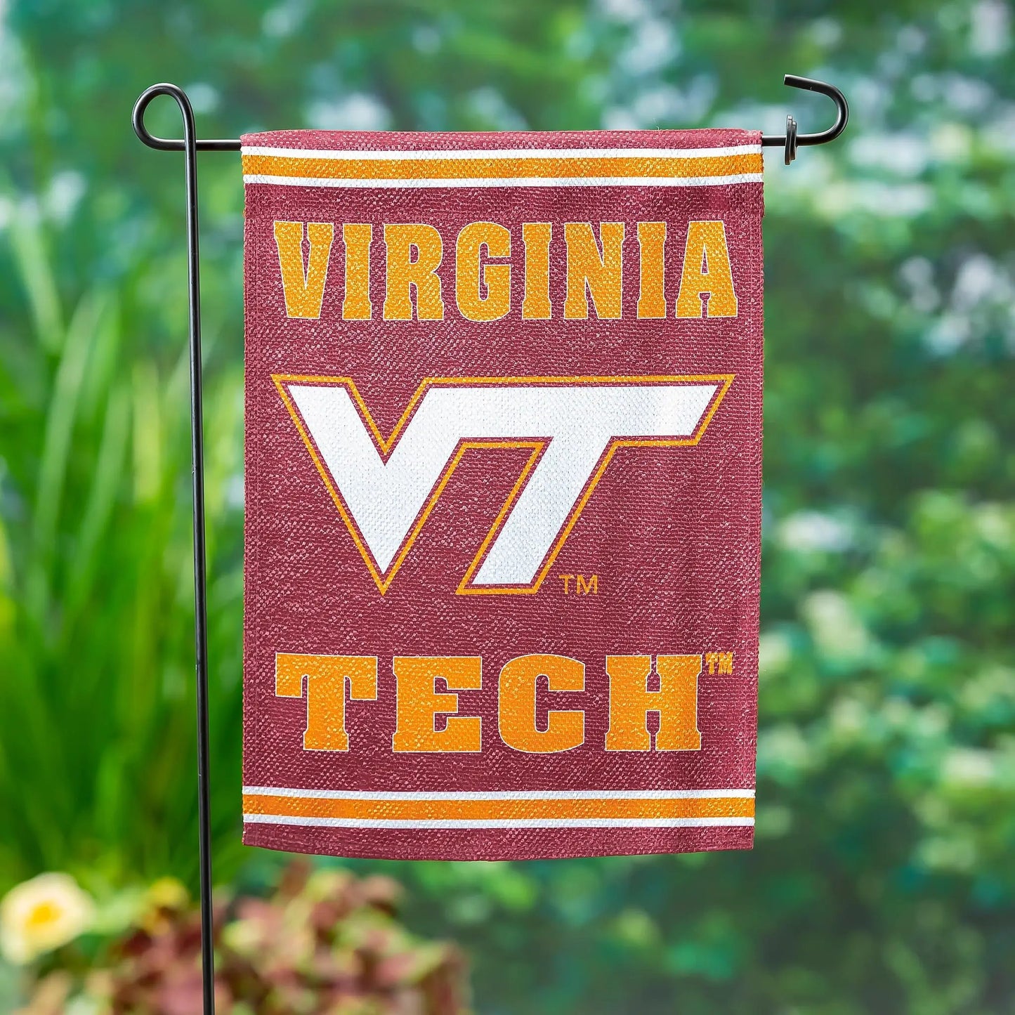 Embossed Suede Flag GDN Virginia Tech in maroon with orange letters on black metal stand on Tampa Home & Garden Store
