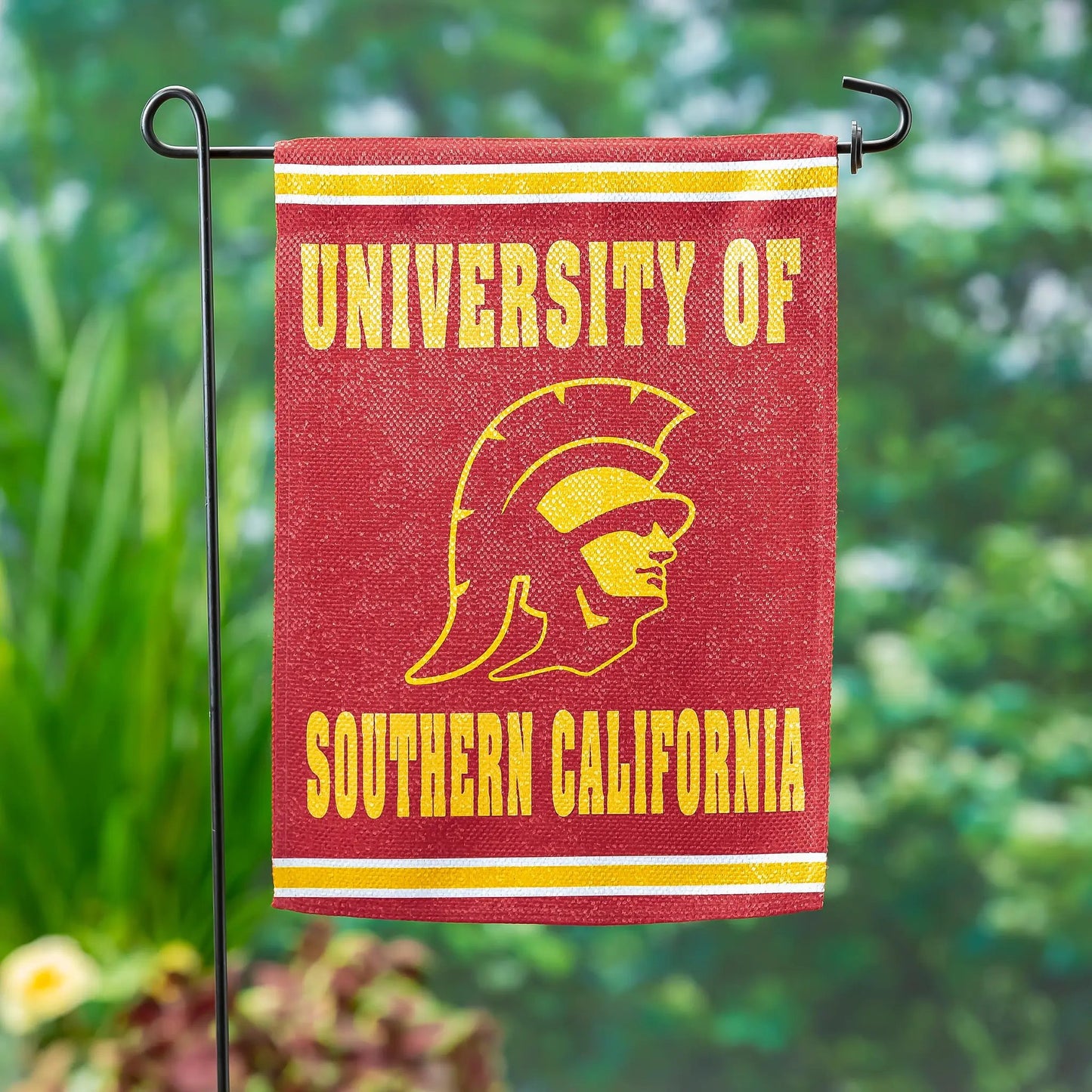 Southern California suede flag with yellow lettering and Trojan emblem on a black stand on Tampa Home & Garden Store