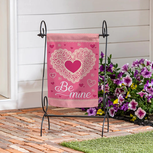 Laced Heart Be Mine Suede Garden Flag in pink with white lace heart design on black metal stand on Tampa Home & Garden Store