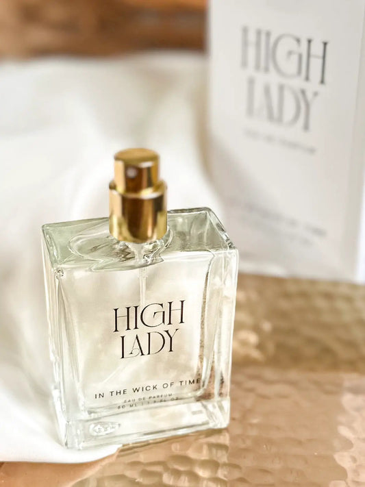 High Lady perfume bottle in clear glass with a gold spray cap; packaging in background on Tampa Home & Garden Store