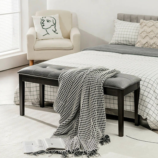 Upholstered PU dining bench with button tufting, dark wood legs at foot of grid bed on Tampa Home & Garden Store