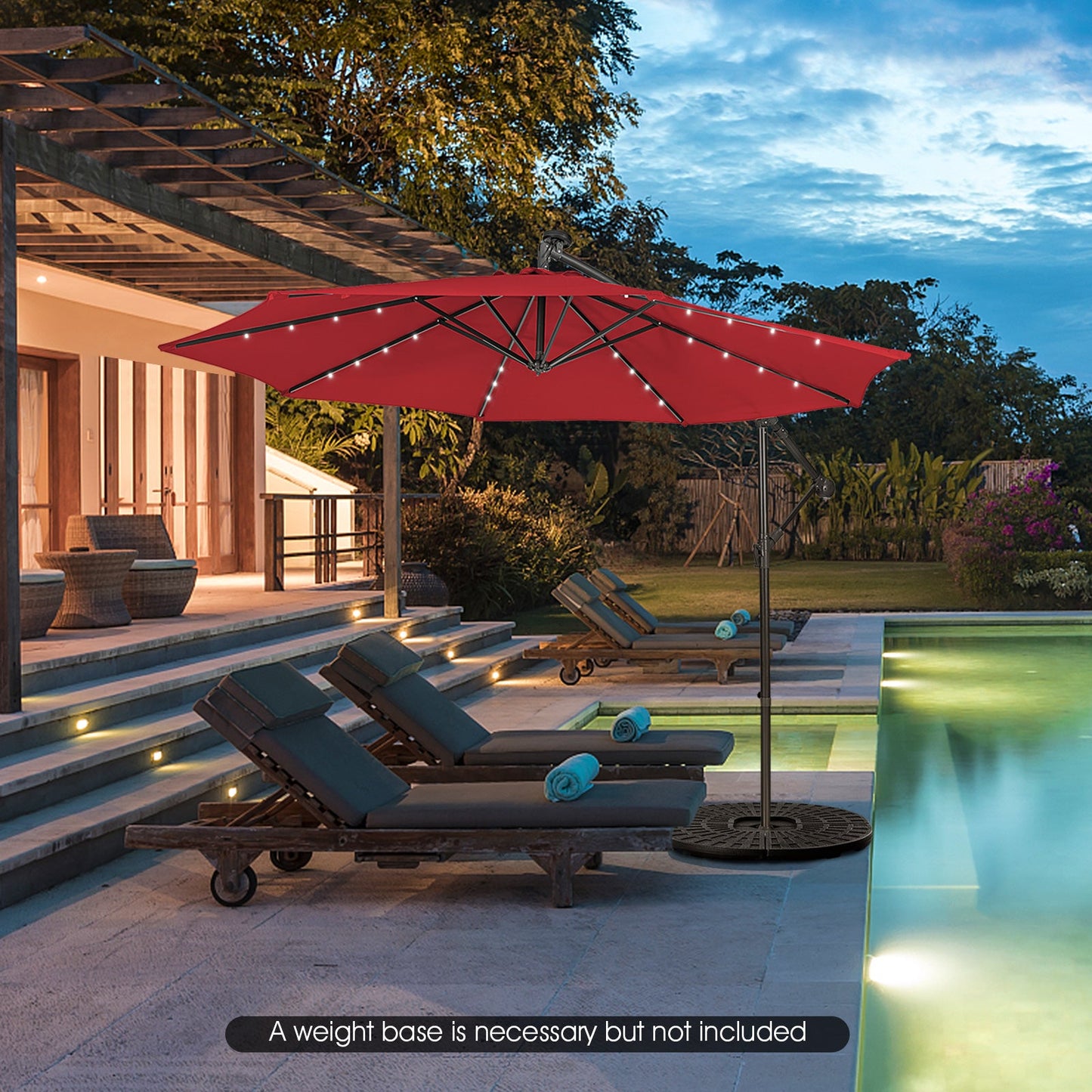 Outdoor red patio umbrella with string lights over poolside lounge chairs by a modern deck on Tampa Home & Garden Store