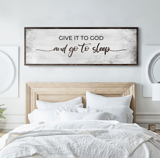 Canvas sign with whitewashed finish and dark wood frame reading GIVE IT TO GOD and go to sleep on Tampa Home & Garden Store