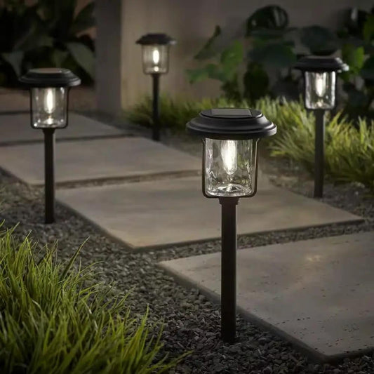 Solar LED Path Light Set Black, 4-pack with lantern-style glass tops along a stone walkway on Tampa Home & Garden Store
