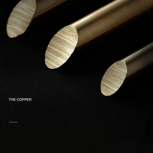 Nordic chandelier copper tubes close-up; three brushed copper rods on black background on Tampa Home & Garden Store