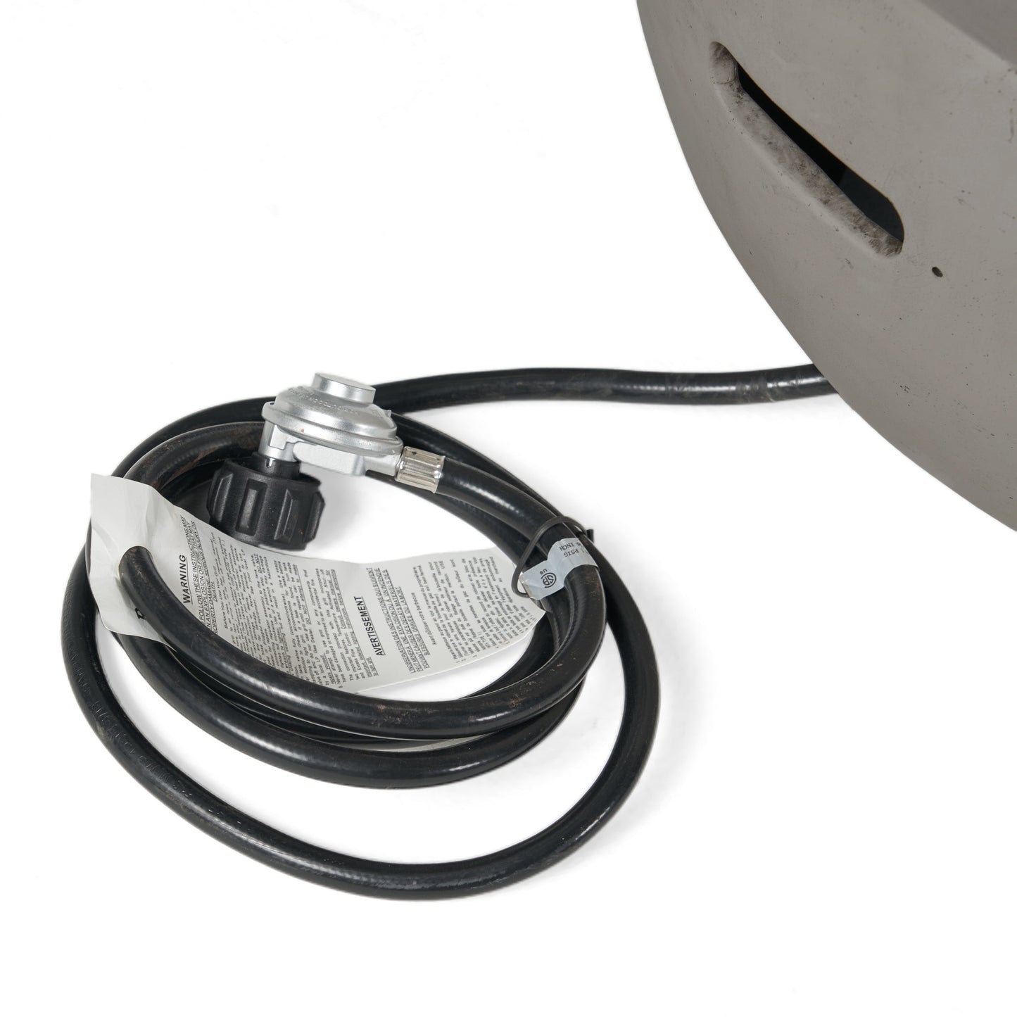 Fire pit gas hose and regulator with valve beside a light grey bowl edge, HouseOfZazla on Tampa Home & Garden Store