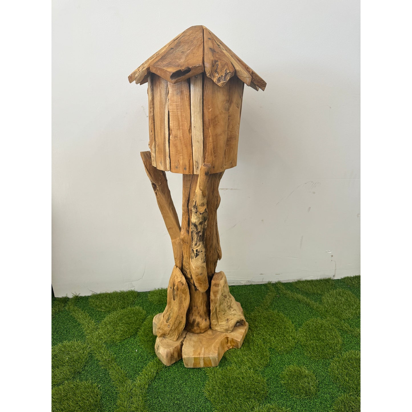 Hand carved teak bird house with peaked roof on rustic stand by The Broward Design Center on Tampa Home & Garden Store