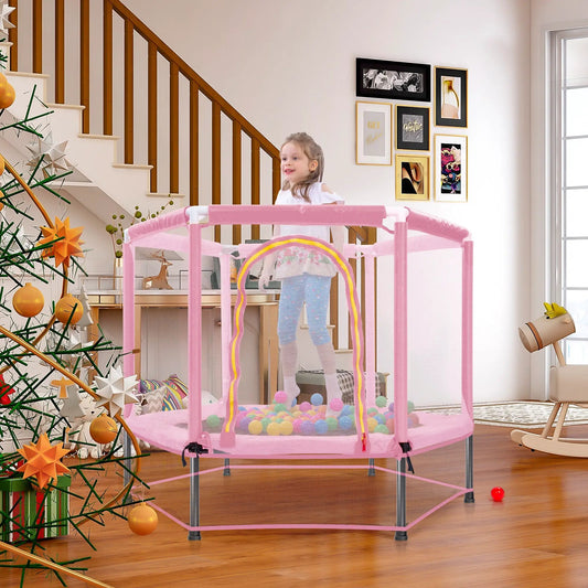 Pink 55-inch toddler trampoline with enclosure in a living room beside a Christmas tree on Tampa Home & Garden Store
