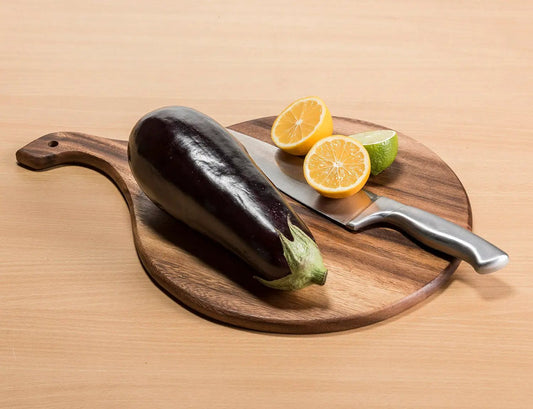 Acacia wood round charcuterie board with stainless knife and citrus slices on Tampa Home & Garden Store