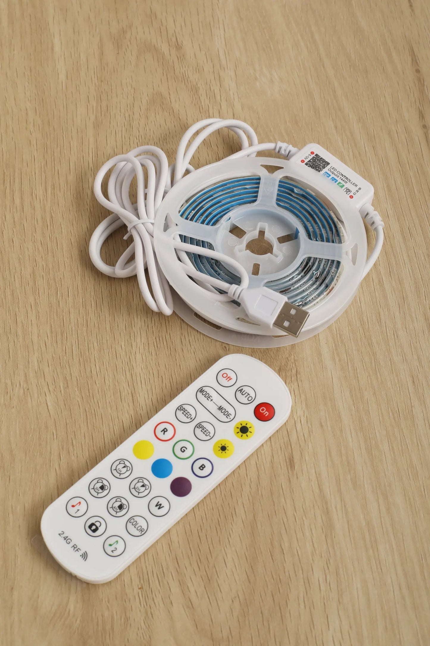 LED strip light reel with USB connector and handheld remote on wood surface on Tampa Home & Garden Store