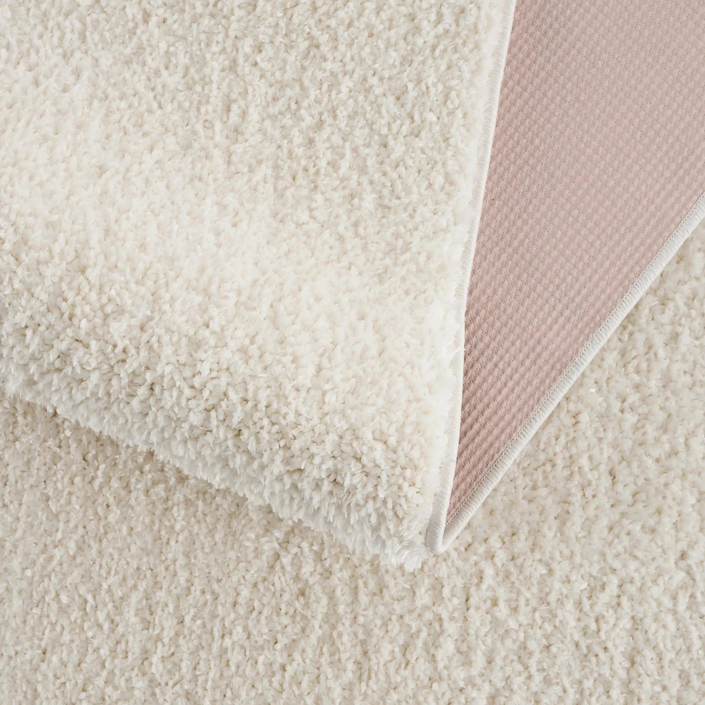 Judy white washable area rug by Boutique Rugs; ivory shag with pink backing on Tampa Home & Garden Store