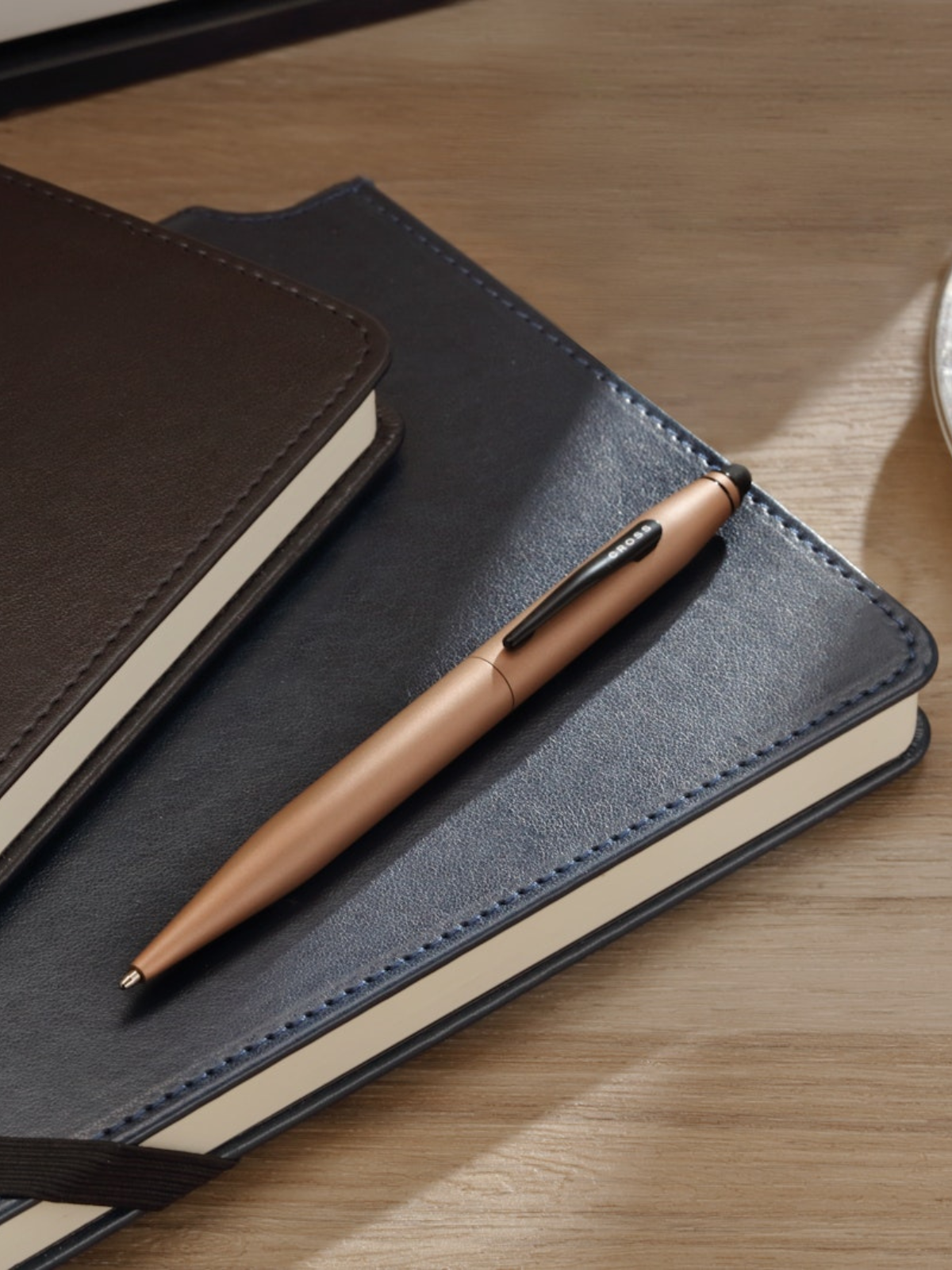 A.T. Cross Tech2 Macchiato ballpoint pen on blue leather journal beside a brown notebook in a gift set on Tampa Home & Garden Store