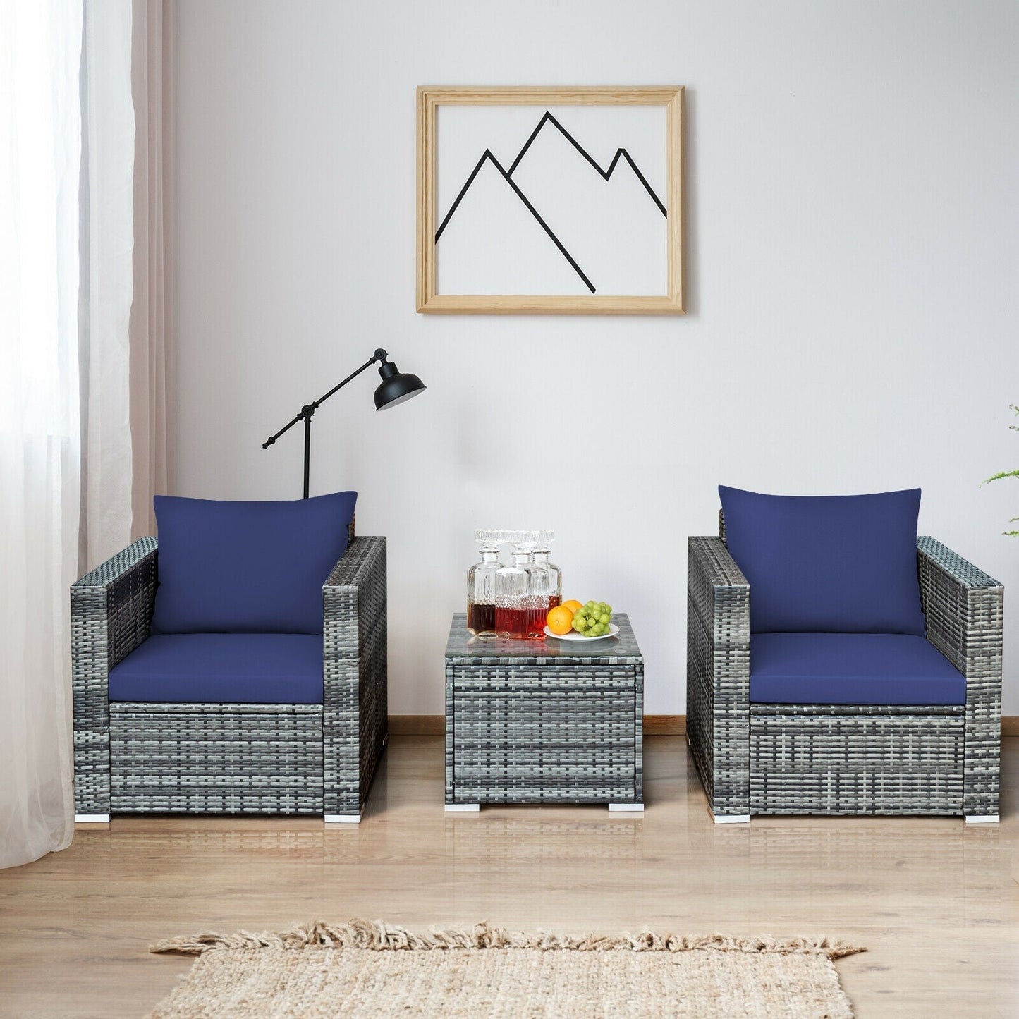 GemGear outdoor movable grill table with gray wicker chairs and blue cushions in a casual lounge on Tampa Home & Garden Store