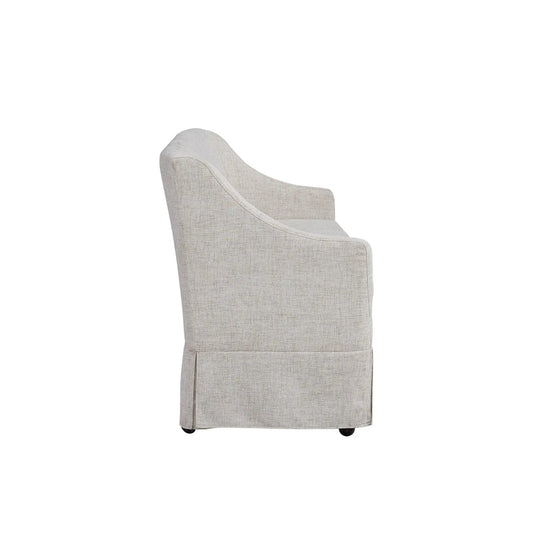 Beige slipcovered settee on casters with curved armrest on Tampa Home & Garden Store