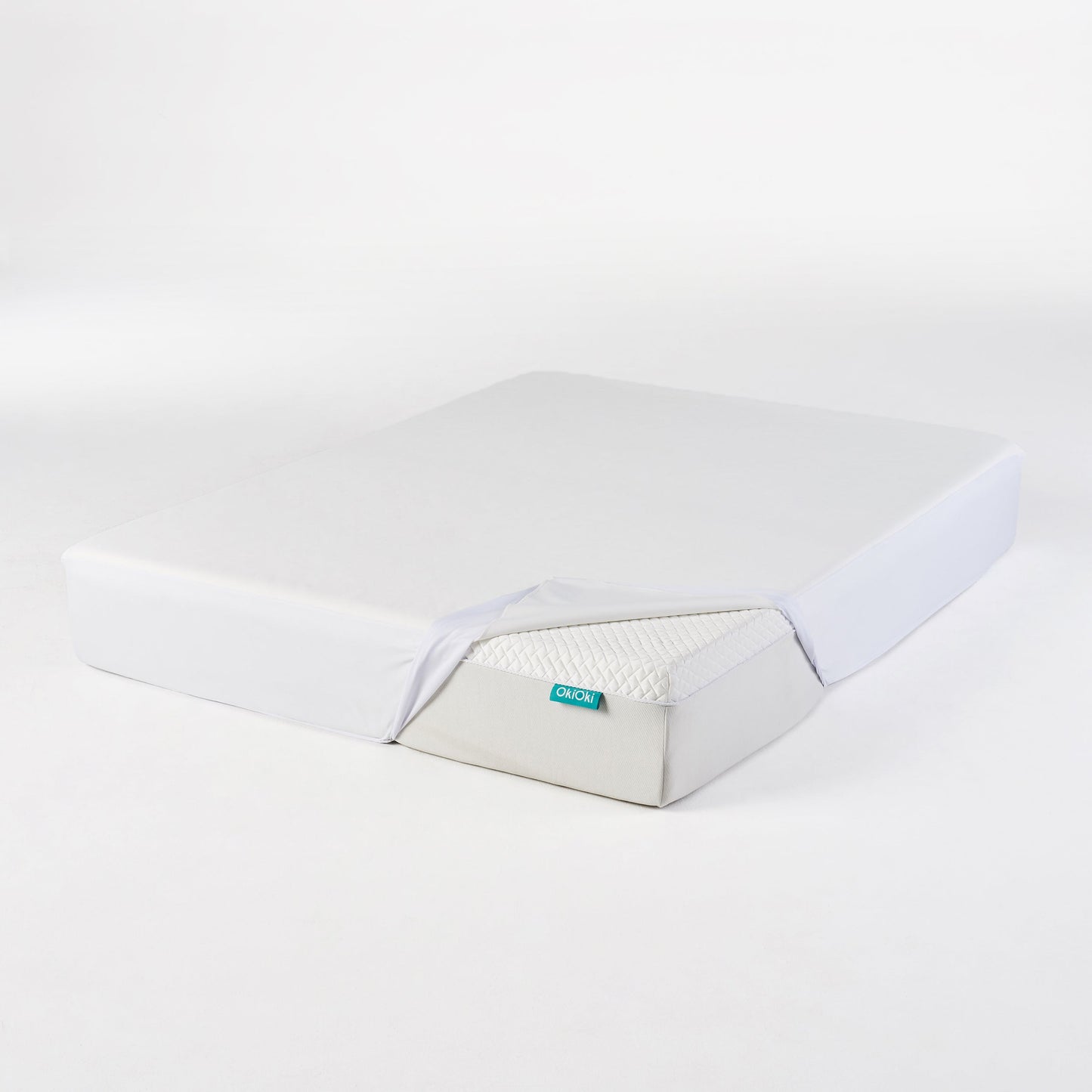 OkiOki King Mattress Protector by HouseOfZazla in light gray fabric with turquoise tag on Tampa Home & Garden Store