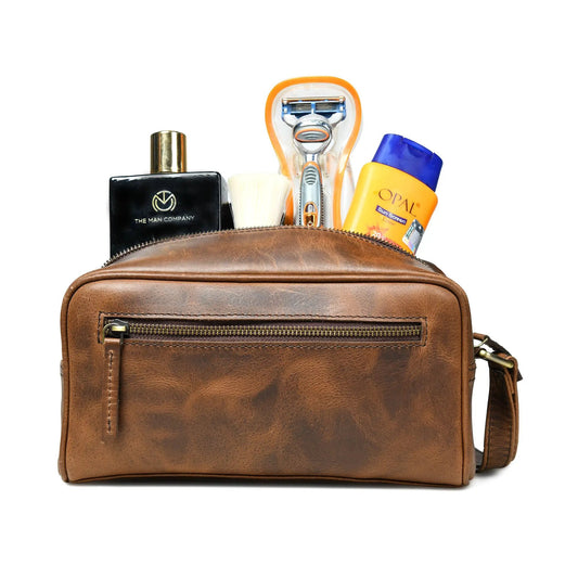 Lumber Toiletry Dopp Kit in brown leather with The Man Company bottle, razor, brush, sunscreen on Tampa Home & Garden Store