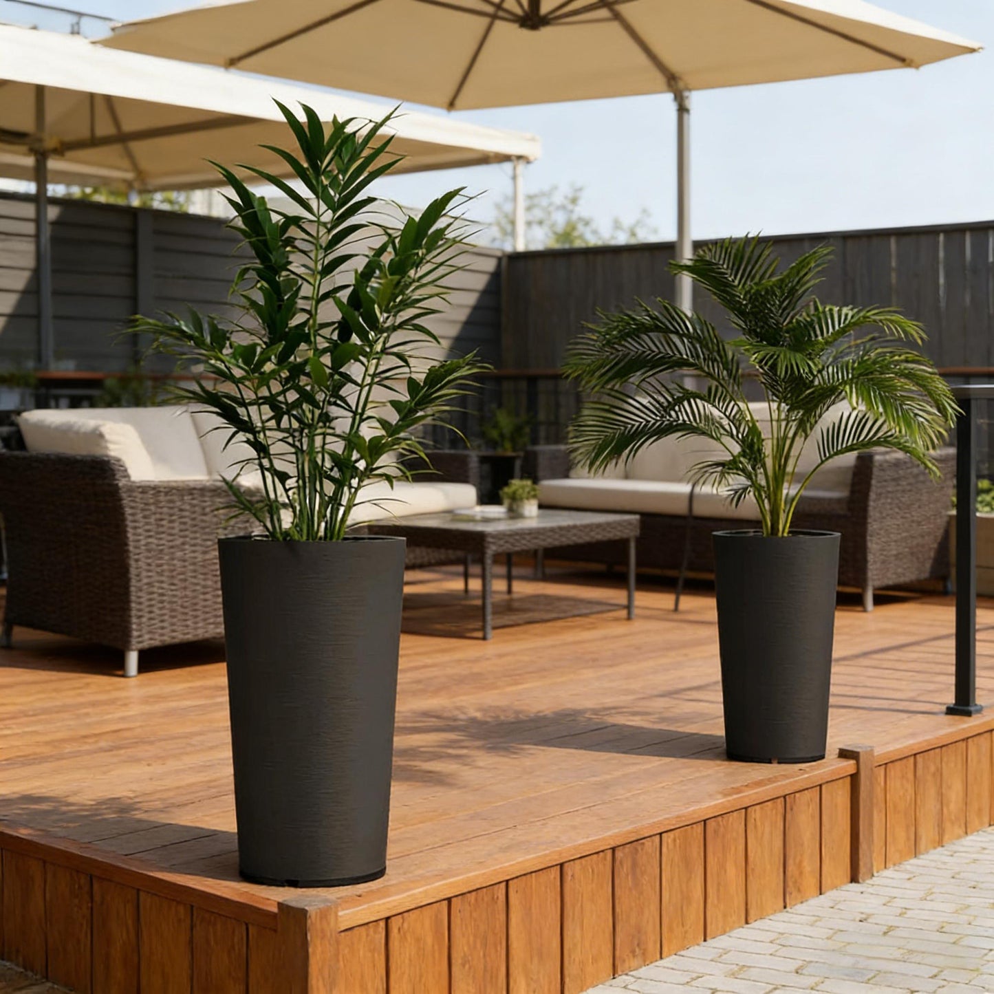 Set of 2 stackable large flower pots in matte black with tall green plants on Tampa Home & Garden Store