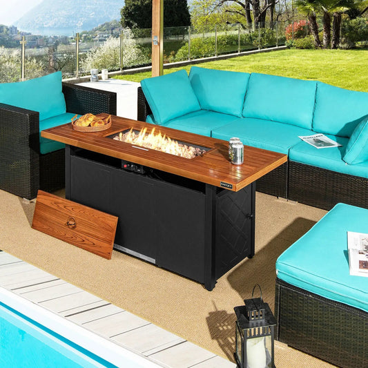 57 Inch 50,000 BTU propane fire pit table with wood top and black base beside teal cushions on Tampa Home & Garden Store