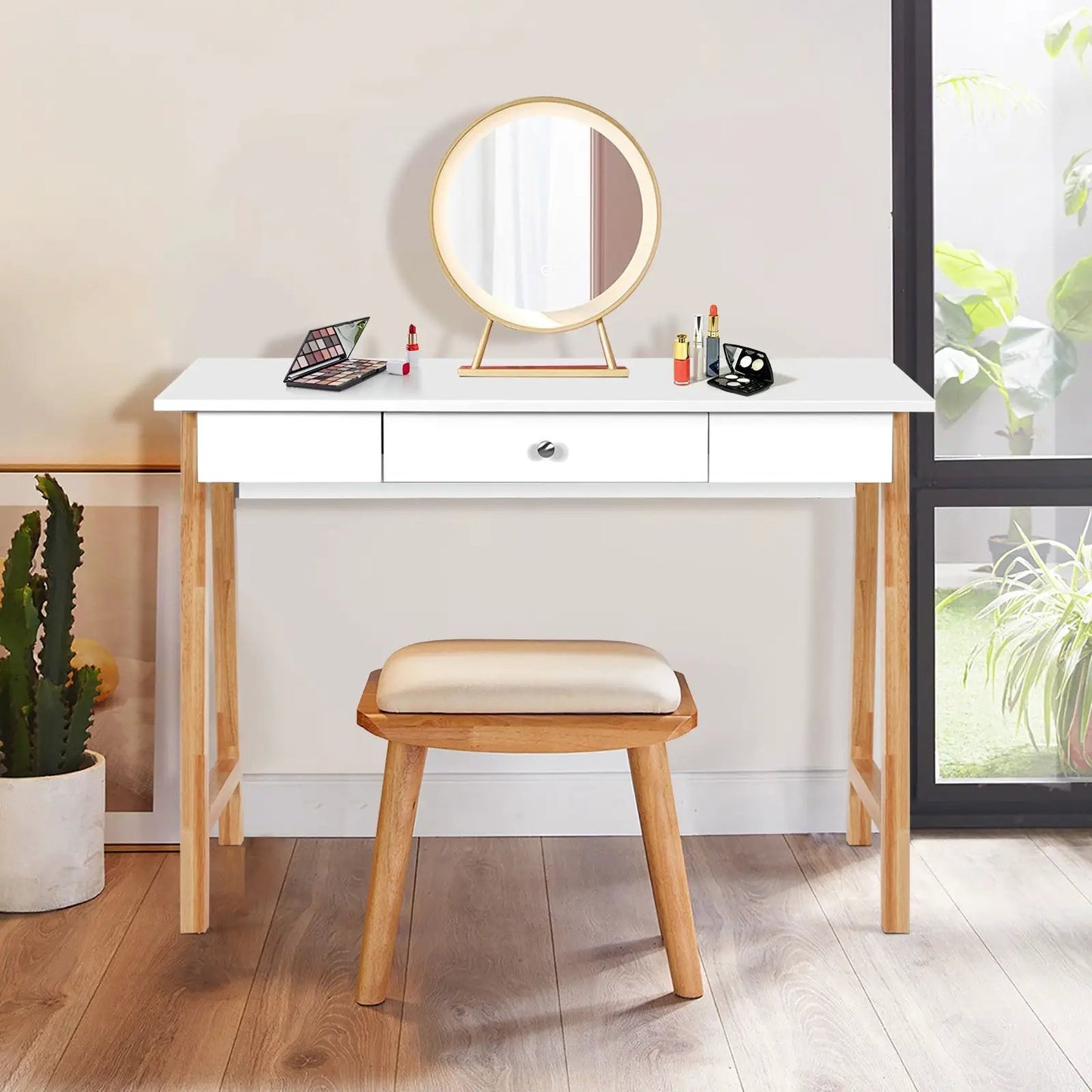 Makeup vanity desk with round gold-framed mirror, white top, wooden legs, cosmetics on Tampa Home & Garden Store