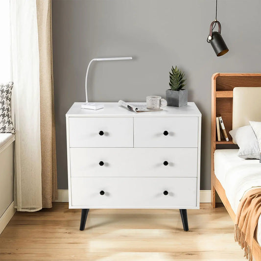 White 4-drawer dresser with black knob pulls in a tidy bedroom setup on Tampa Home & Garden Store