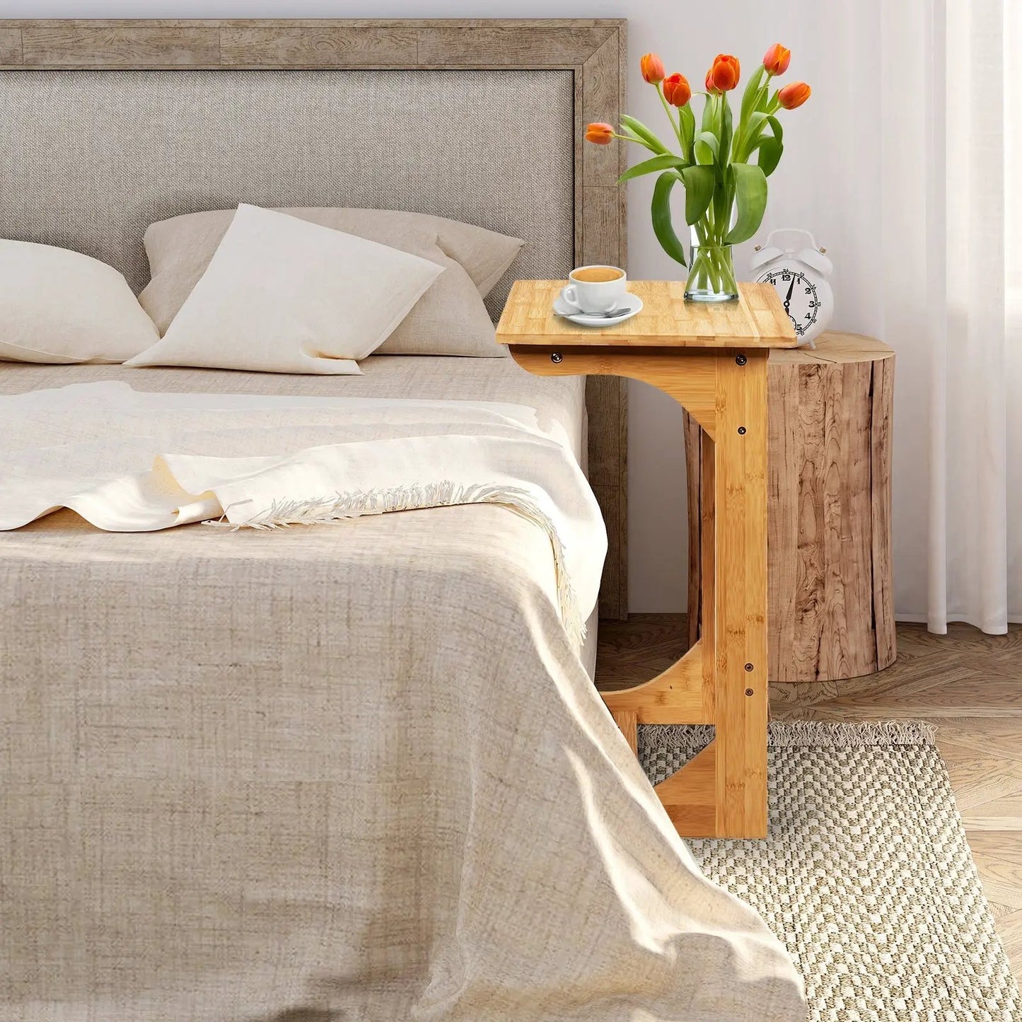 Bamboo sofa end table with storage bag beside bed, tulips and coffee in a cozy bedroom on Tampa Home & Garden Store