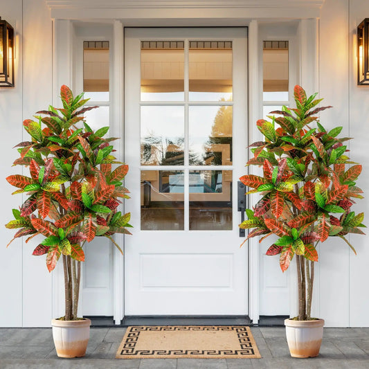 Pair of 5 ft tall DirectDeals artificial croton plants with nursery pots, leaves flanking door on Tampa Home & Garden Store