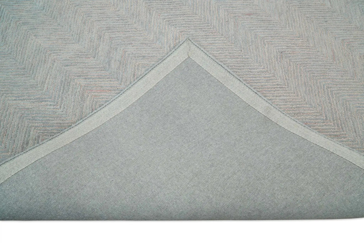 Area rug handmade woolen pink and gray with pale zigzag pattern; underside visible on Tampa Home & Garden Store