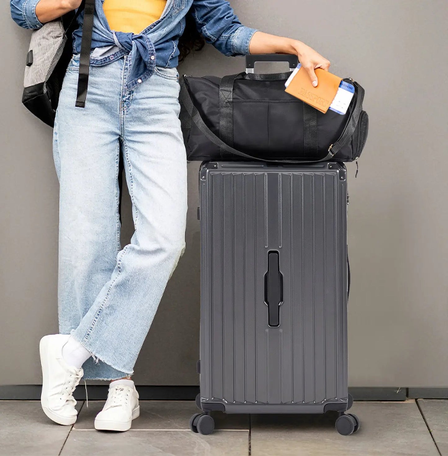 Gray hard-shell suitcase with a black duffel bag on top on Tampa Home & Garden Store