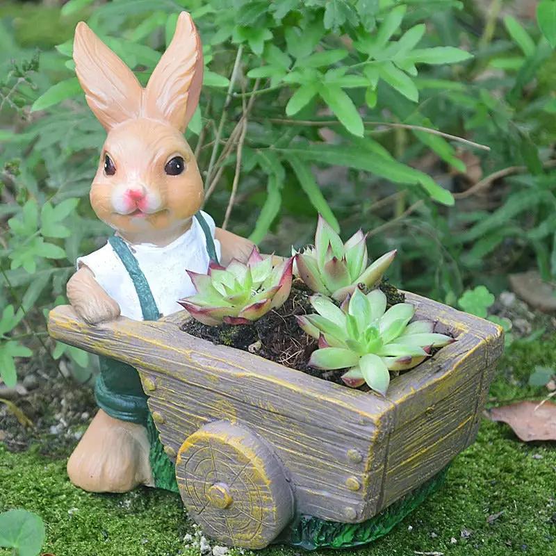 Succulent plant pot with rabbit resin ornament in a weathered gray wheelbarrow planter on Tampa Home & Garden Store