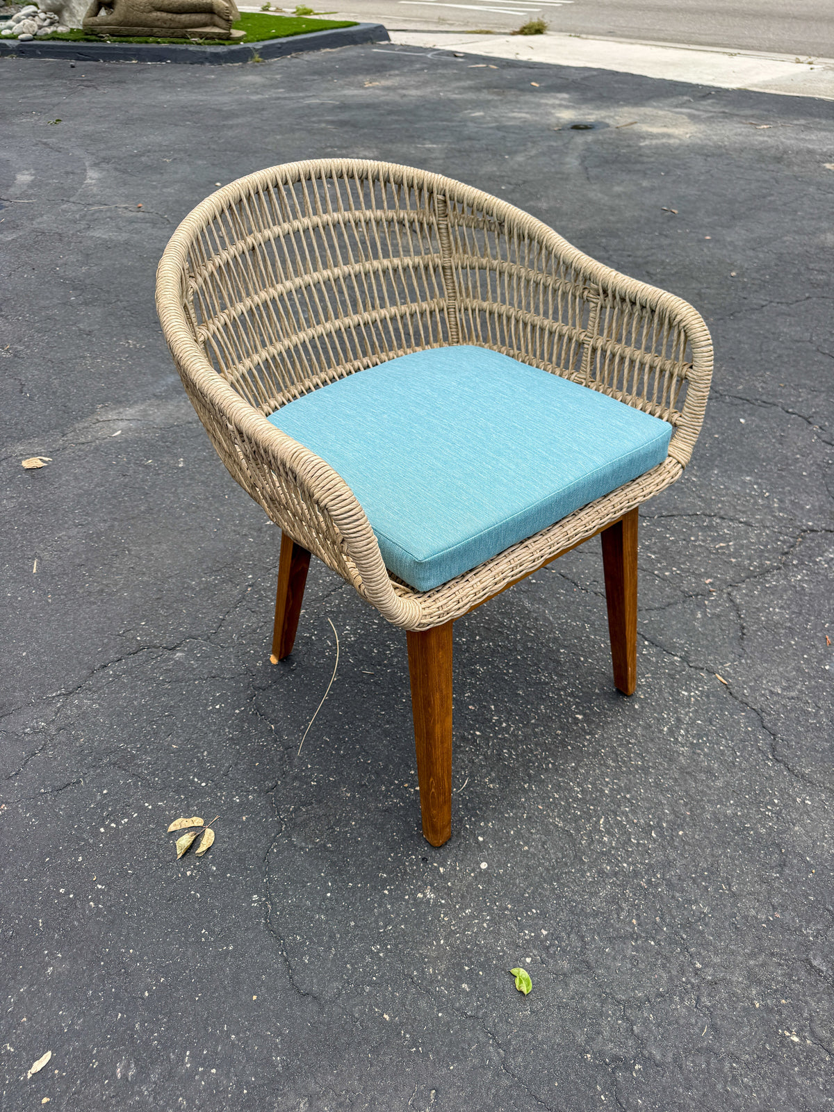 Synthetic rope and teak arm chair with blue cushion, outdoor wicker-style seat on teak legs on Tampa Home & Garden Store