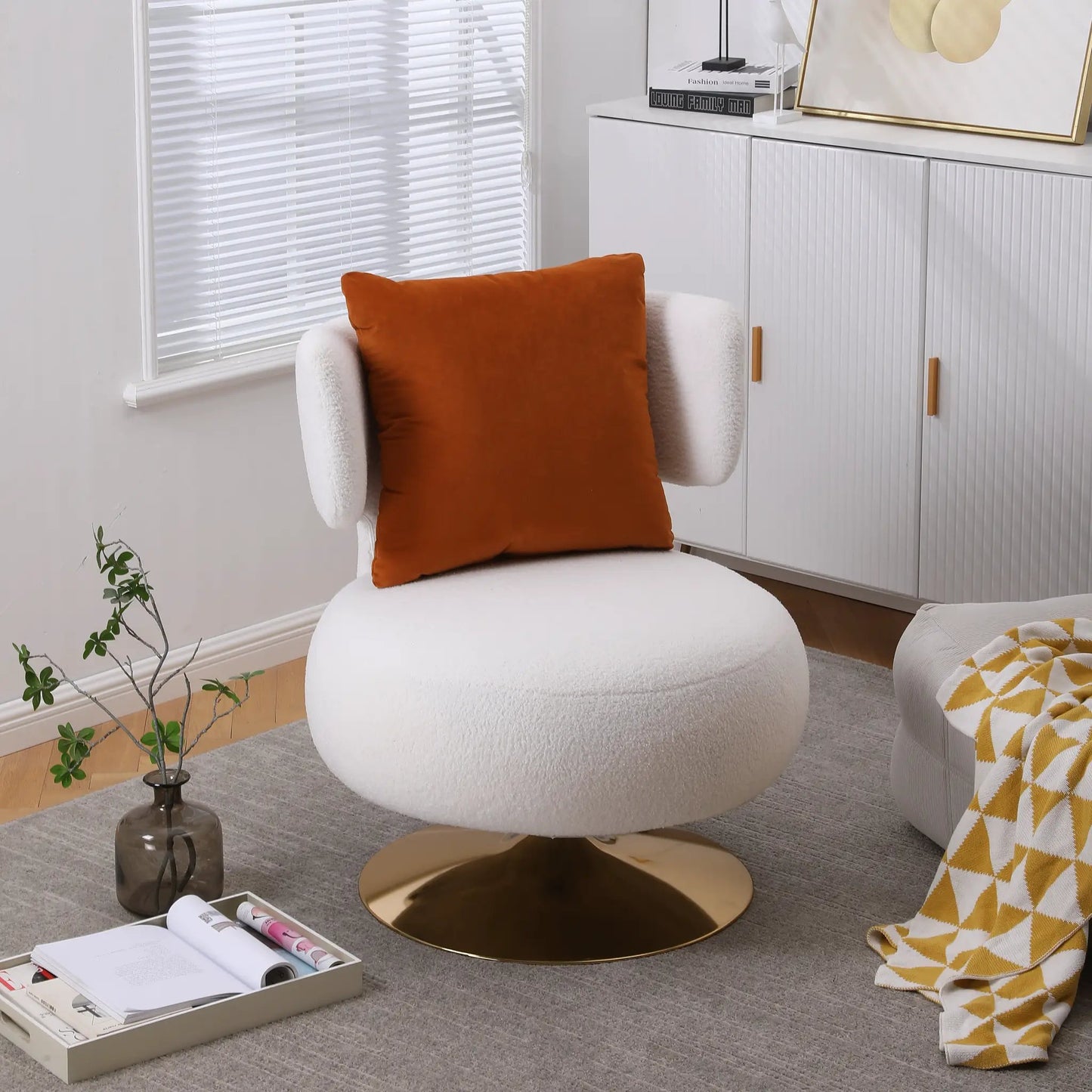 Swivel accent round barrel chair white fabric with orange throw pillow in living room on Tampa Home & Garden Store