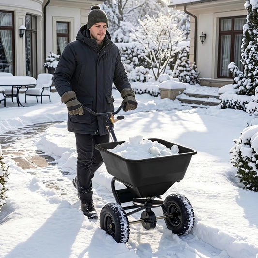 Walk-behind broadcast lawn spreader DirectDeals, black hopper, 13-inch tires on snow on Tampa Home & Garden Store