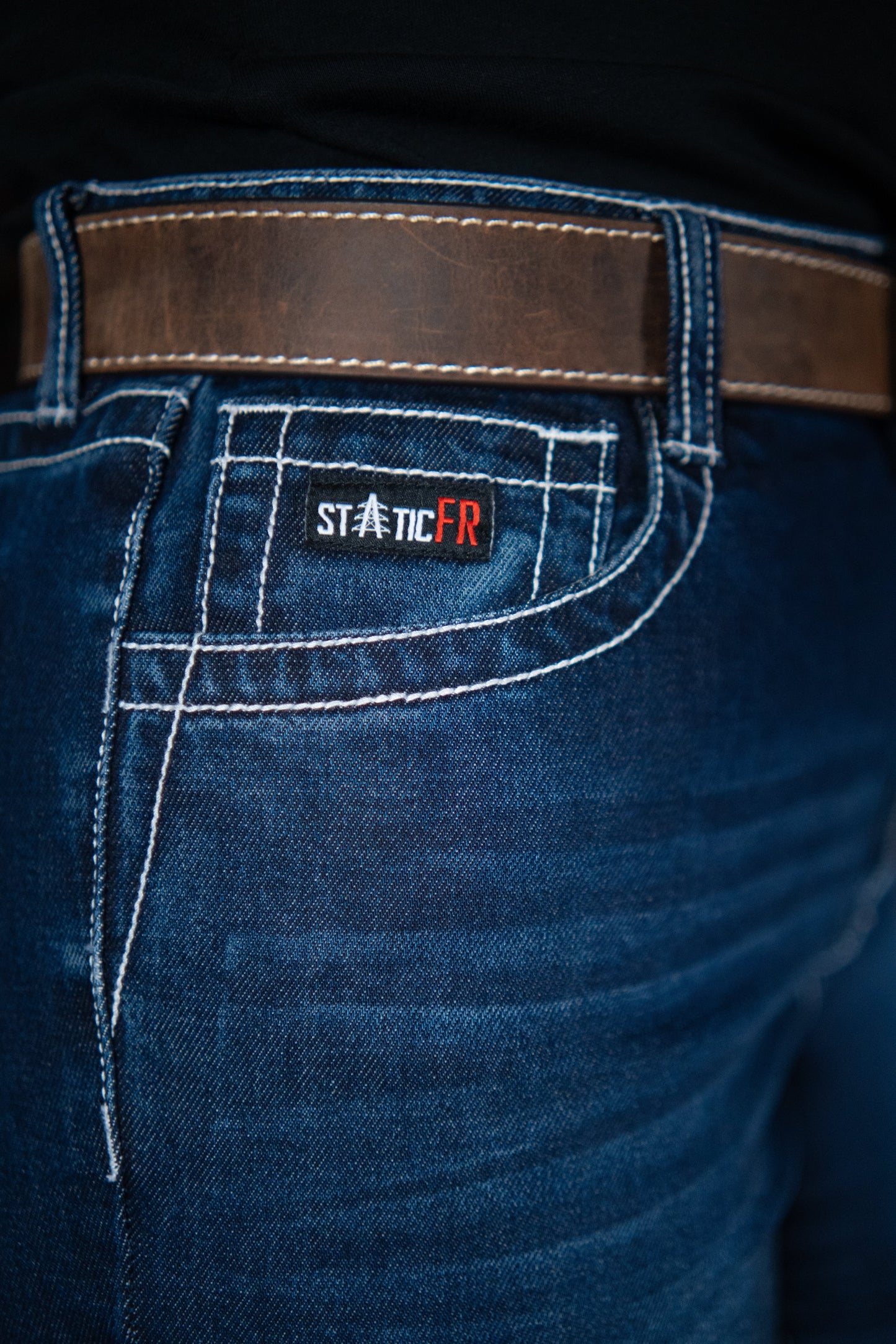 Women’s FR jeans denim with brown belt and Static FR patch on back pocket on Tampa Home & Garden Store