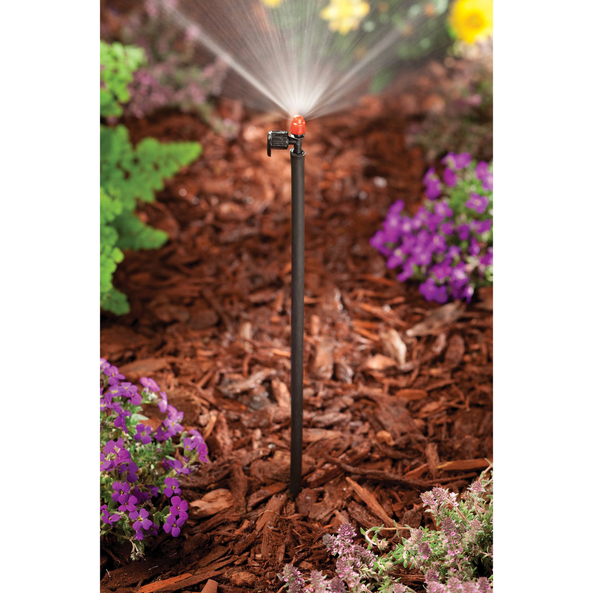 Drip riser 1/2 in MPT x 12 in Orbit Irrigation with orange cap spraying water in garden on Tampa Home & Garden Store