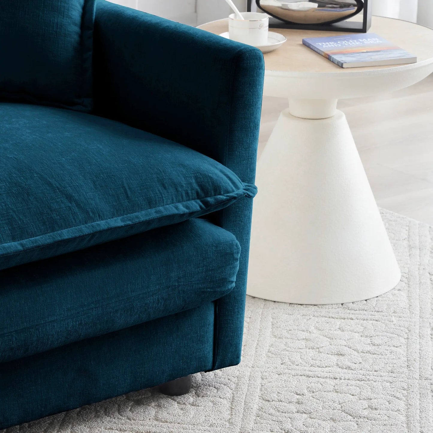 Blue chenille modular sofa close-up with curved arm in a modern living room on Tampa Home & Garden Store