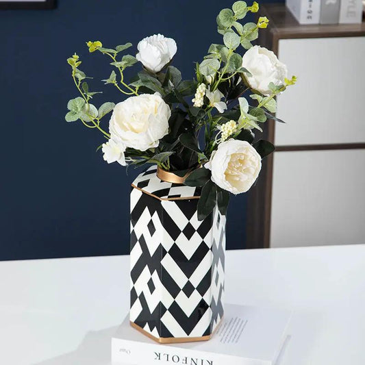 Geometric black and white striped ceramic storage jar vase with copper trim and faux white roses on Tampa Home & Garden Store