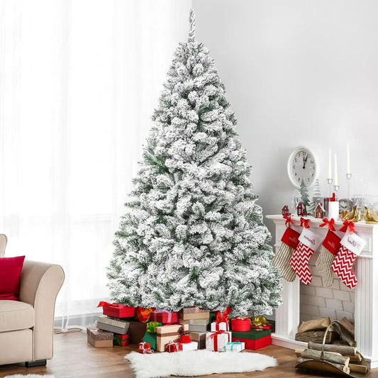 6 Foot snow flocked pine Christmas tree with metal stand amid wrapped gifts in living room on Tampa Home & Garden Store