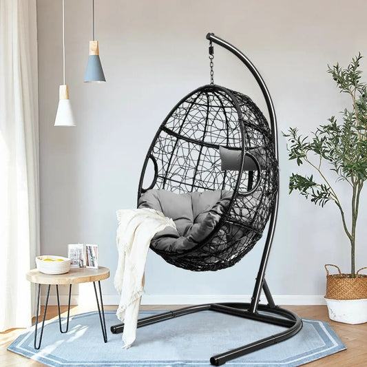Hanging cushioned hammock chair with stand in black woven frame and gray cushions on Tampa Home & Garden Store