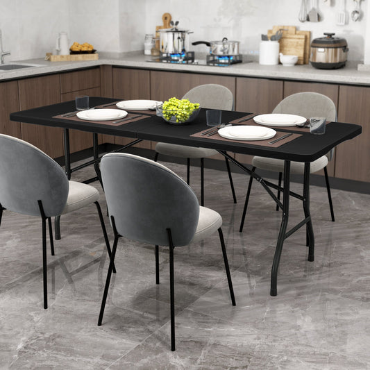 GemGear 6 ft folding table with black HDPE tabletop, fold-in-half design, four gray chairs on Tampa Home & Garden Store