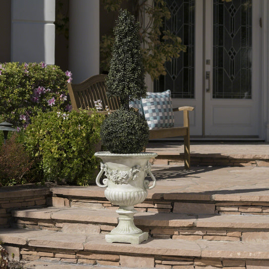 MGO garden urn planter with dense cone-shaped topiary on a carved stone pedestal on Tampa Home & Garden Store