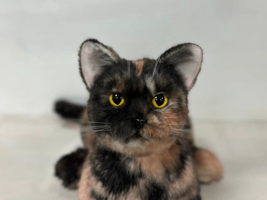 Plush tortoiseshell cat life-size memorial by Chongker, head and ears with vivid yellow eyes on Tampa Home & Garden Store