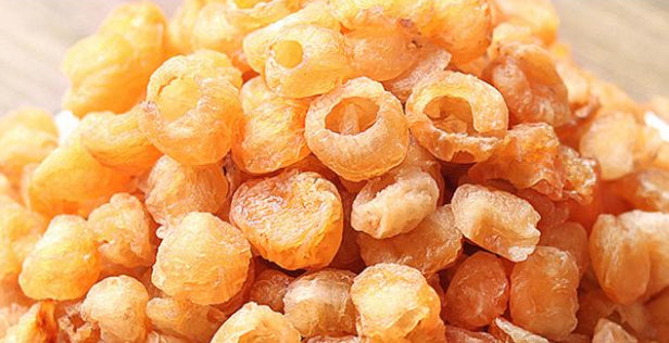 Ring-shaped dried longan pieces, orange-yellow color with hollow centers on Tampa Home & Garden Store