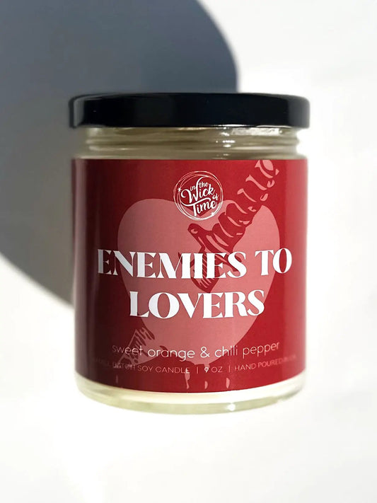 Enemies to Lovers Candle 9 oz by In the Wick of Time with red label and black lid on Tampa Home & Garden Store