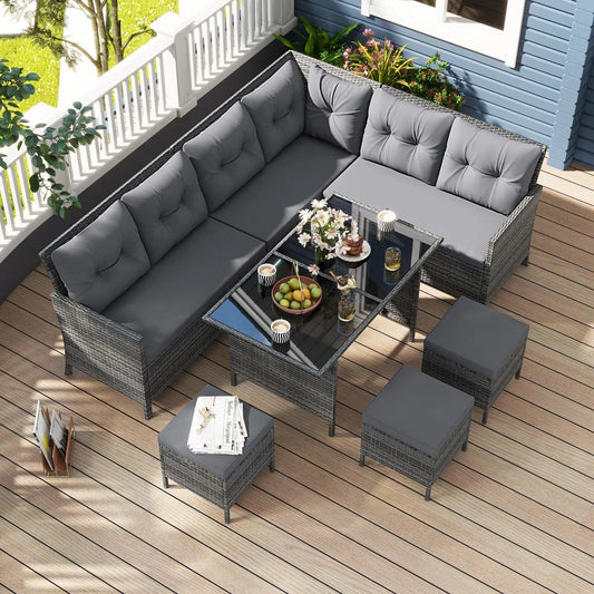 7-piece outdoor wicker dining set with gray cushions, glass-top table, and ottomans on Tampa Home & Garden Store
