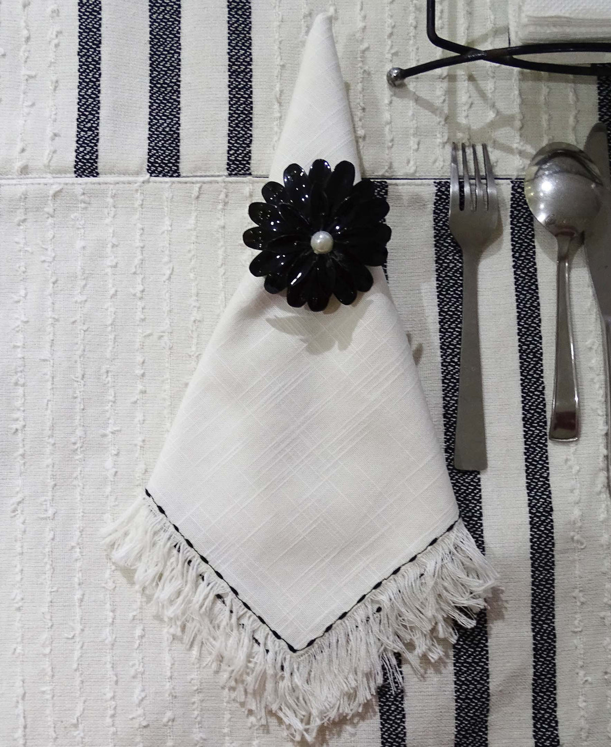 Vibhsa cotton table napkins set of 4 white with subtle weave and a black floral napkin ring on Tampa Home & Garden Store