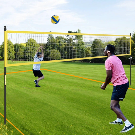 Portable outdoor volleyball net set with yellow framed posts on grassy field, players in action on Tampa Home & Garden Store