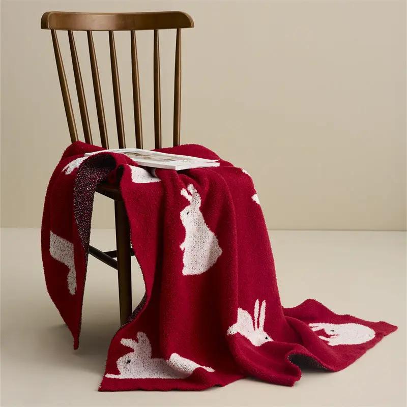 New Year Rabbit Blanket and Sofa Blanket Scarf red with rabbits draped over a wooden chair on Tampa Home & Garden Store