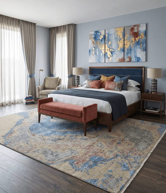 8x10 hand-knotted beige and blue modern area rug under a bed in a blue-gray bedroom with art on Tampa Home & Garden Store
