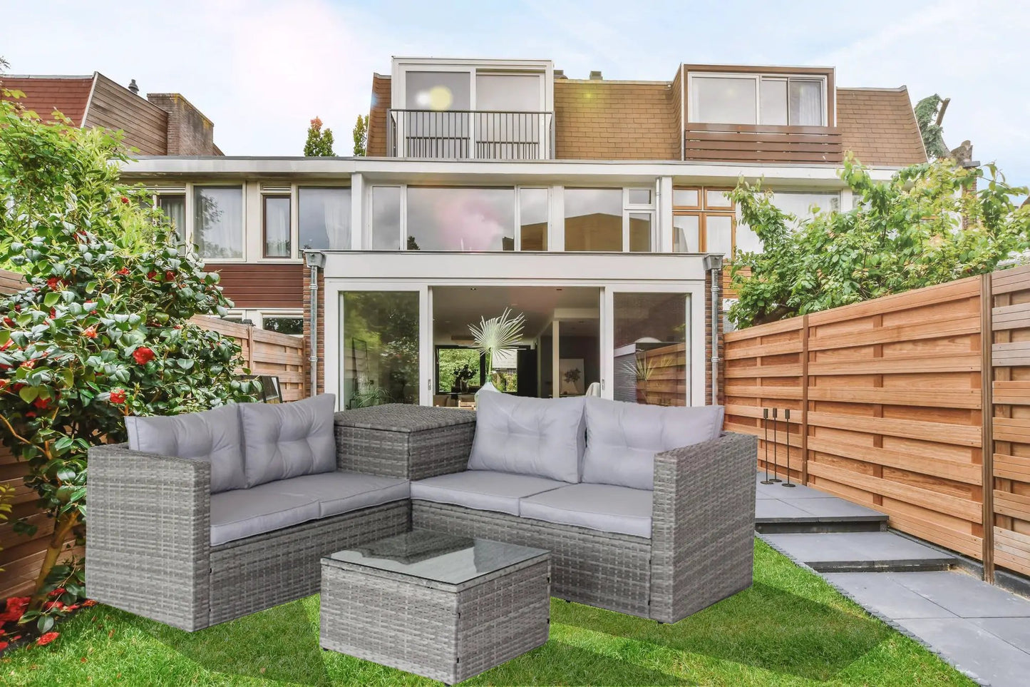 Grey 4-piece patio wicker sectional sofa set with plush cushions in a modern backyard lounge on Tampa Home & Garden Store