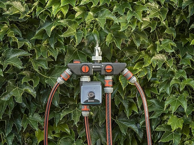 Gardena Water Control Bluetooth watering controller with red hoses and mounting hub on Tampa Home & Garden Store